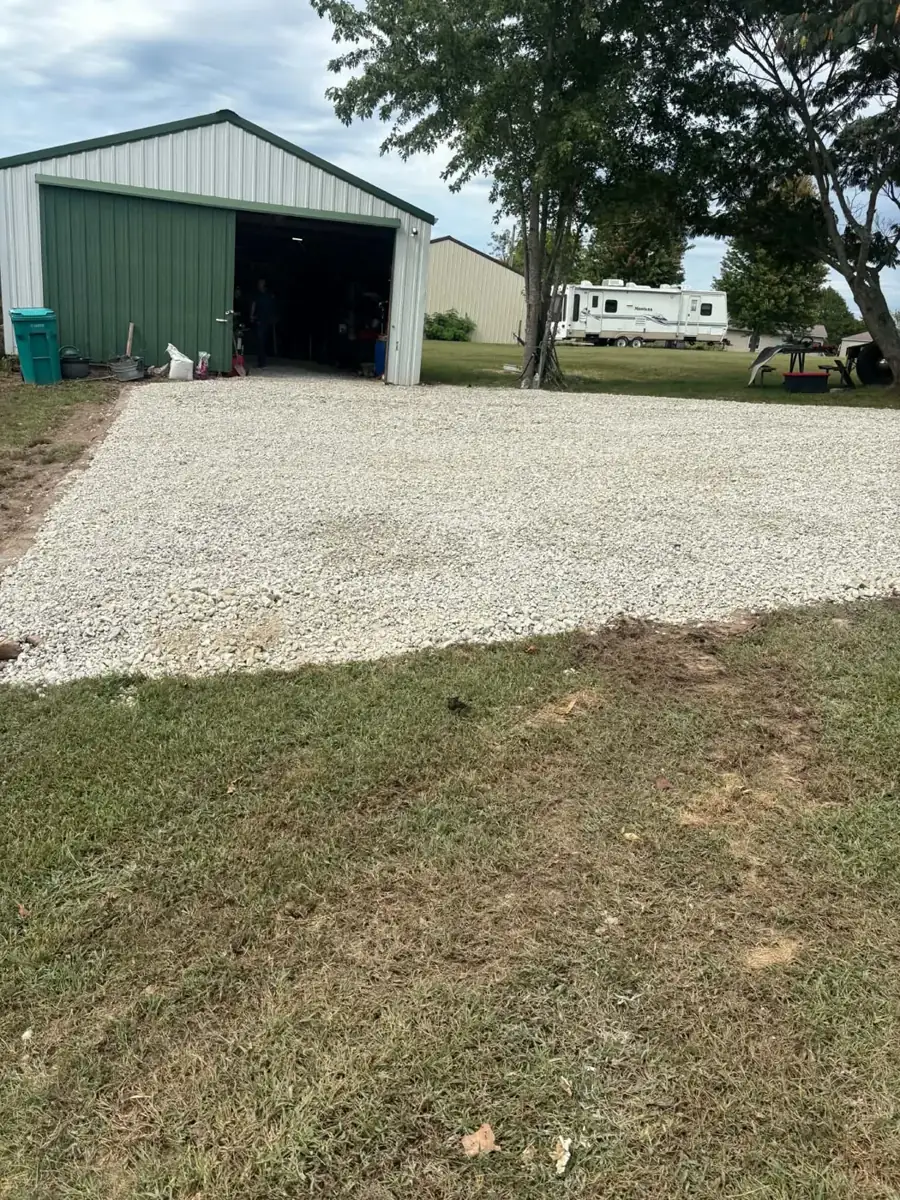 New white gravel pad in front of a green metal shop