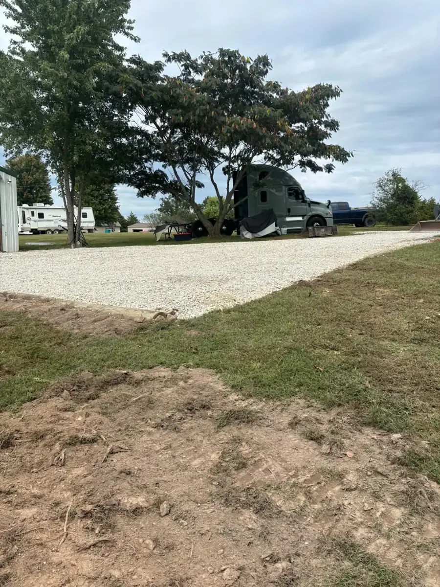 Level gravel pad finished next to a lawn